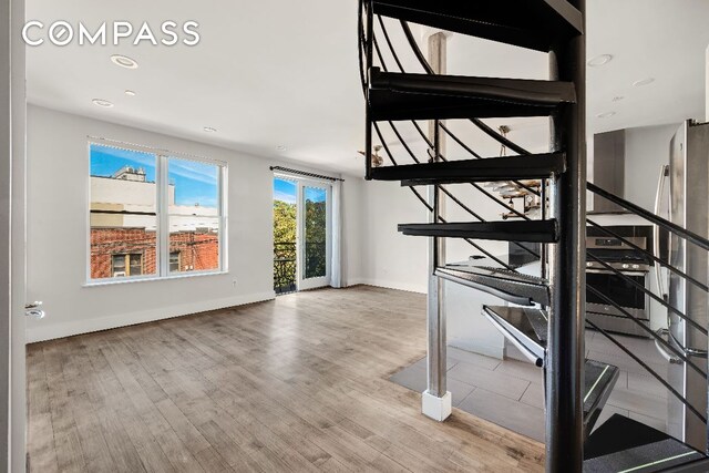 stairs featuring recessed lighting, baseboards, and wood finished floors