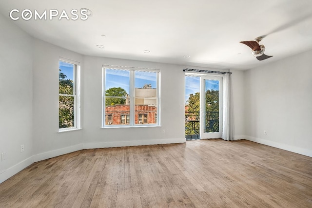 unfurnished room with light wood-style floors and baseboards