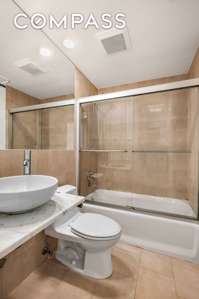 252 Richardson St Unit 3L, New York City, NY 11222 - bathroom with a sink, toilet, bath / shower combo with glass door, and tile patterned floors
