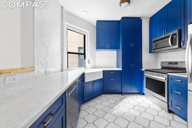 kitchen featuring blue cabinets, sink, and stainless steel appliances