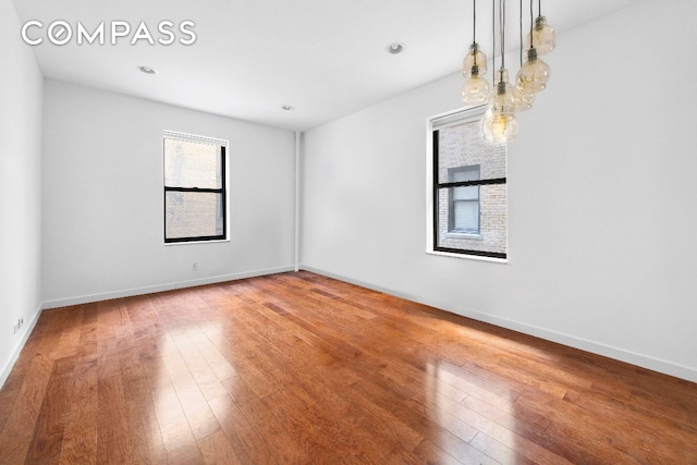 empty room with hardwood / wood-style floors