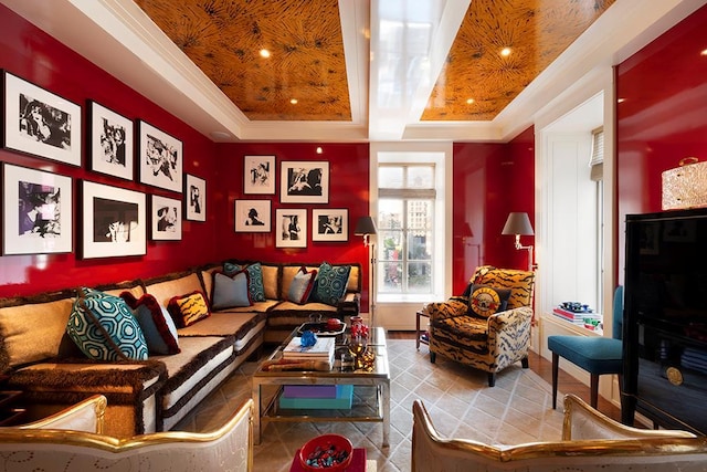 living area featuring a raised ceiling and crown molding