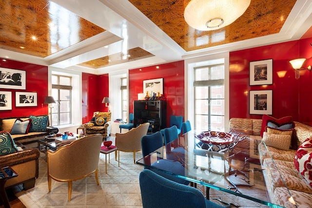 living room with a raised ceiling and crown molding