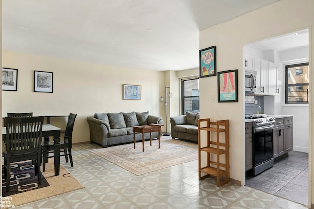 living room with plenty of natural light and baseboards