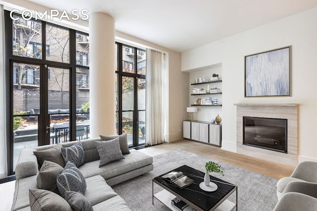 living room with light hardwood / wood-style flooring and a healthy amount of sunlight