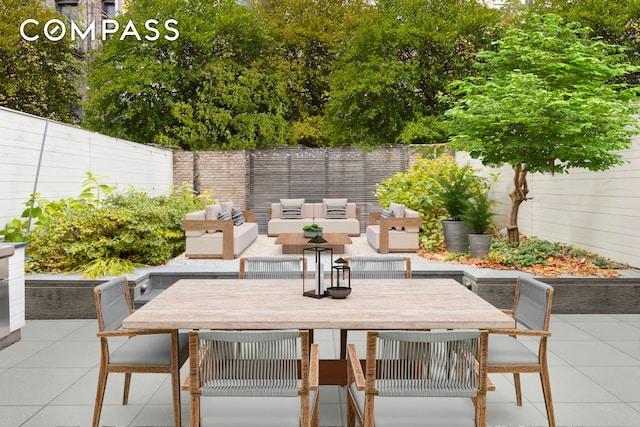 view of patio with outdoor dining space, an outdoor hangout area, and a fenced backyard