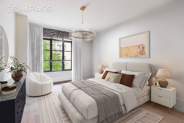 215 Sullivan St Unit Thc, New York City, NY 10012 - bedroom with wood finished floors, a chandelier, and baseboards