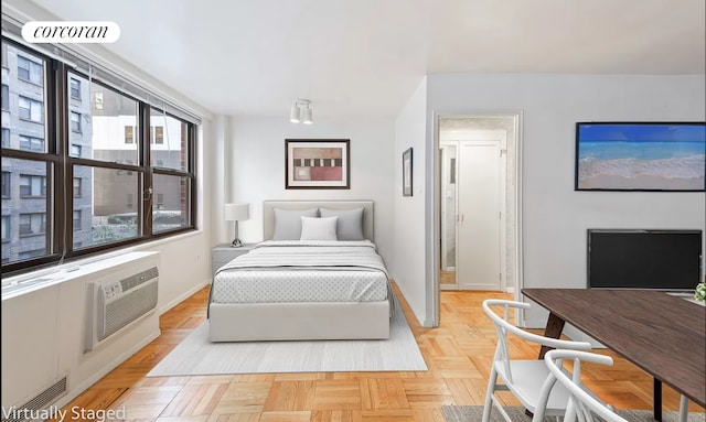 bedroom with light parquet flooring