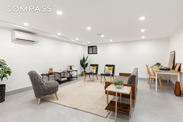 living room with baseboards, concrete flooring, an AC wall unit, and recessed lighting