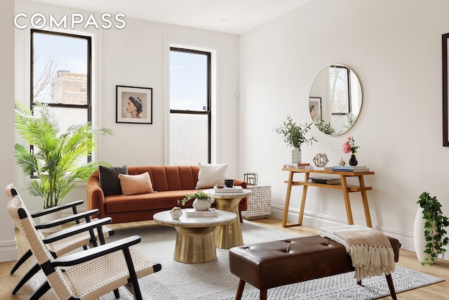 sitting room with light wood-style flooring and baseboards