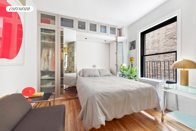 bedroom featuring wood-type flooring and multiple windows