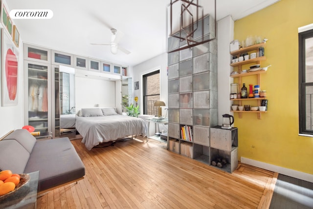 bedroom featuring light wood-type flooring and ceiling fan