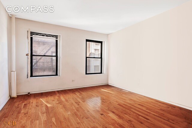 unfurnished room featuring a wealth of natural light and light wood-type flooring