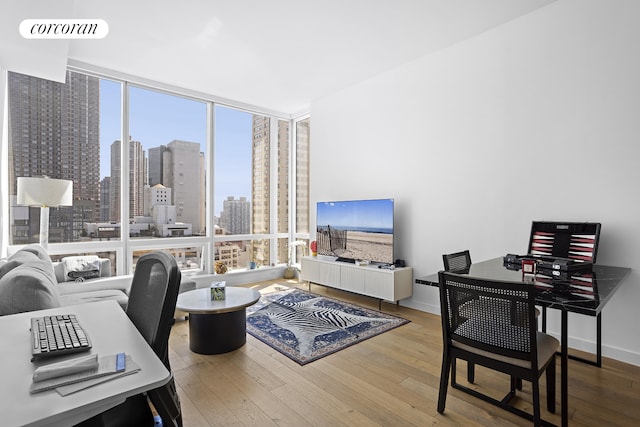 office featuring baseboards, visible vents, and hardwood / wood-style floors