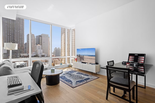 office featuring expansive windows, wood-type flooring, visible vents, and baseboards