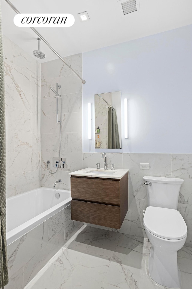 full bath featuring visible vents, toilet, a combined bath / shower with rainfall shower, marble finish floor, and vanity