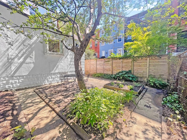 view of yard with a fenced backyard and a garden