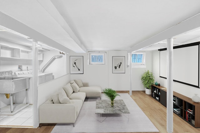 living room featuring light wood-type flooring and separate washer and dryer