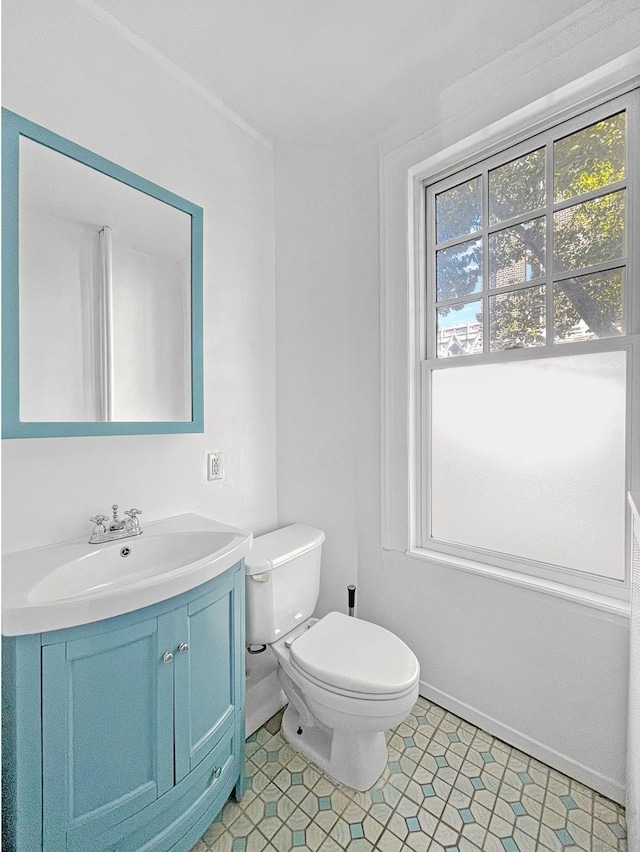 bathroom featuring vanity, toilet, and baseboards