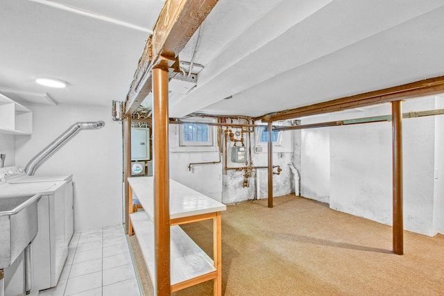 basement featuring light carpet and washer and clothes dryer