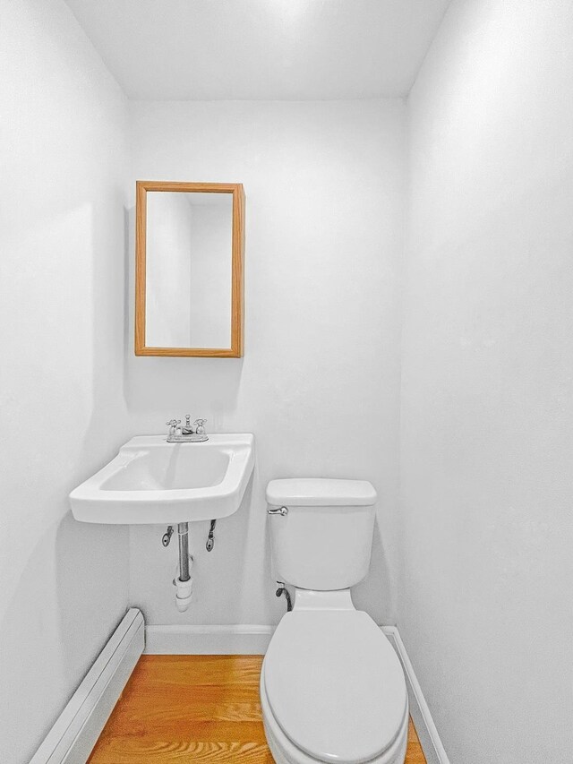 bathroom featuring baseboards, vanity, and toilet