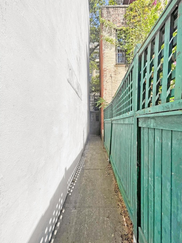 view of property exterior featuring fence and stucco siding