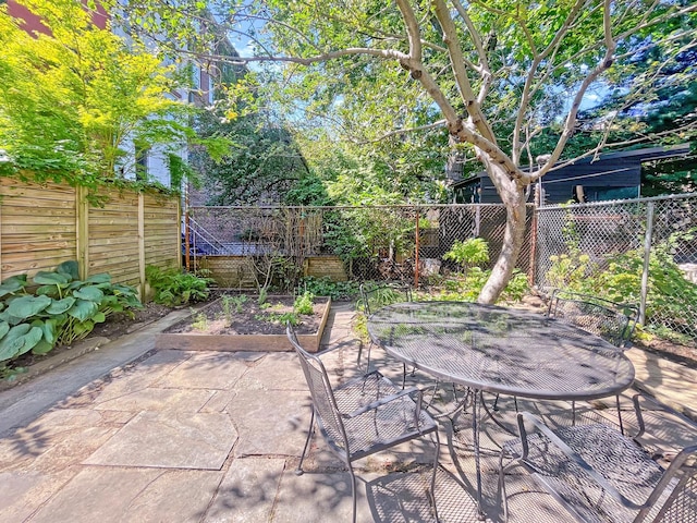 view of patio featuring a fenced backyard and outdoor dining space