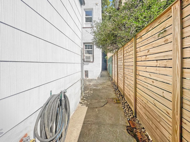 view of home's exterior featuring cooling unit and fence