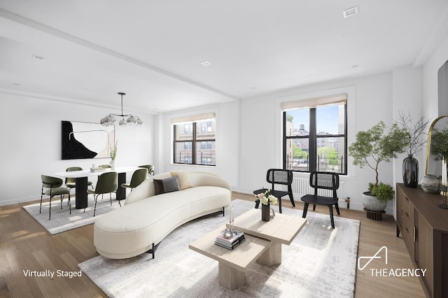 living room with wood-type flooring and a chandelier