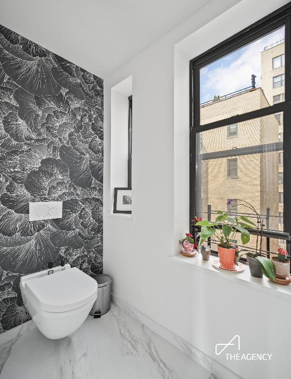 bathroom with tile walls