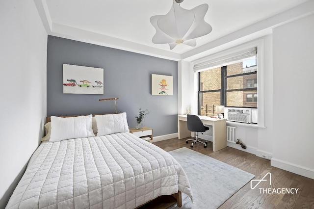 bedroom with cooling unit, ceiling fan, and wood-type flooring