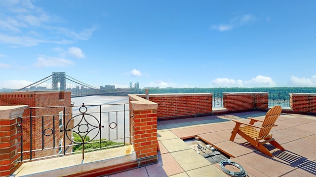 view of patio / terrace with a balcony and a water view