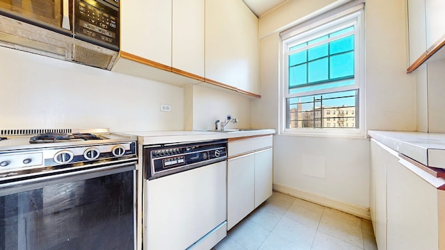 kitchen with white dishwasher, white cabinetry, and gas stove