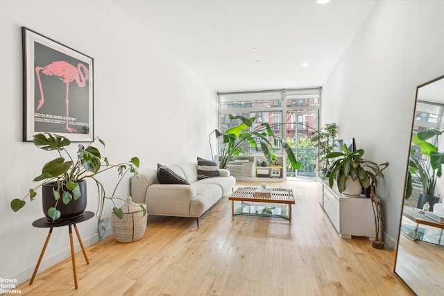 sitting room with recessed lighting, light wood-style flooring, and baseboards