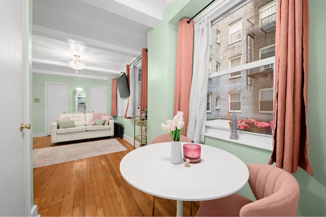 dining area with hardwood / wood-style floors and baseboards