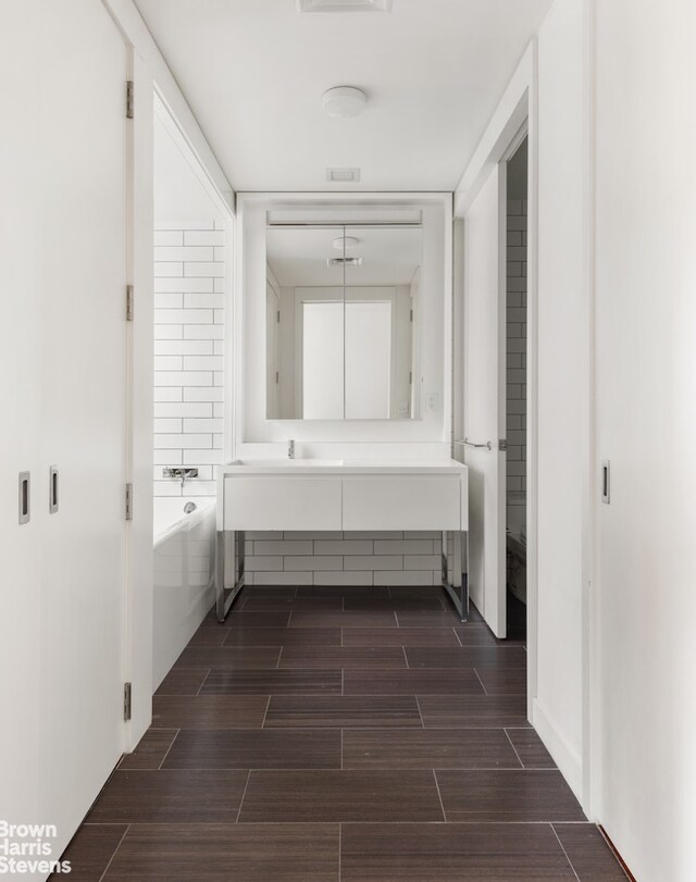15 William St Unit 21A, New York City, NY 10004 - bathroom with vanity, wood finish floors, and a bath