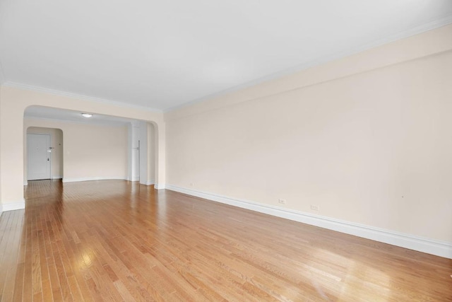 unfurnished room with crown molding and light wood-type flooring