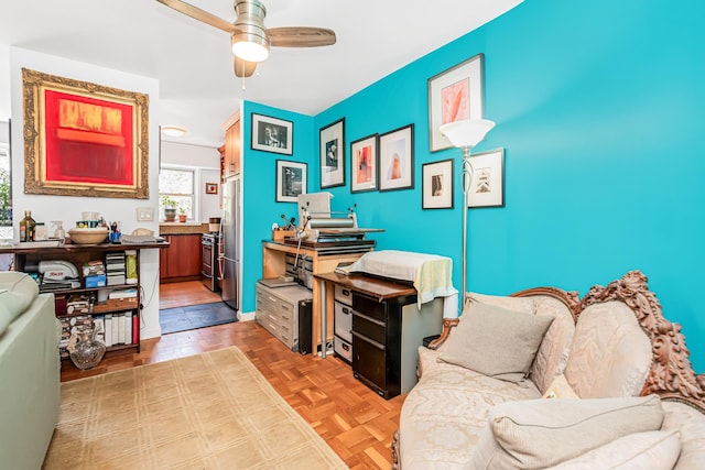 office with parquet flooring and a ceiling fan