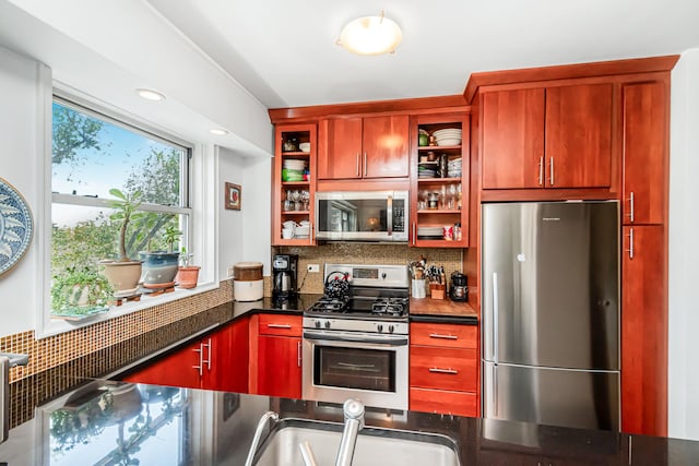 kitchen with a sink, open shelves, stainless steel appliances, decorative backsplash, and dark brown cabinets