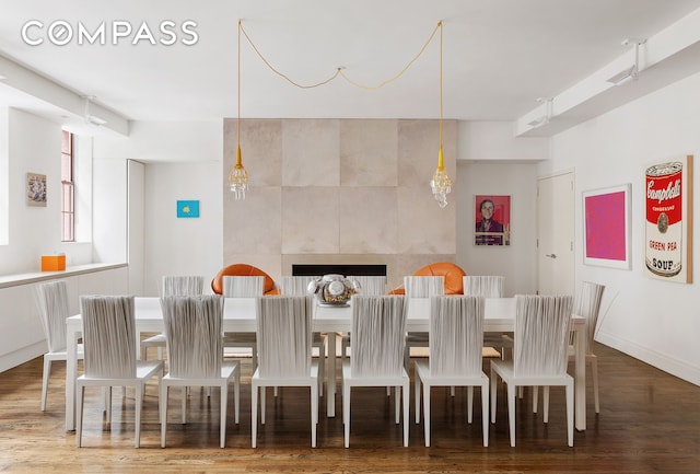 dining room with baseboards and wood finished floors