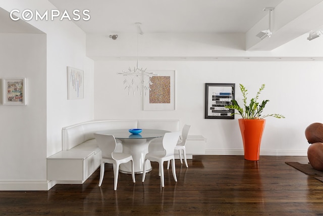 dining room with baseboards and wood finished floors