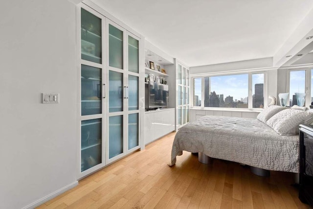 bedroom featuring light hardwood / wood-style floors and multiple windows