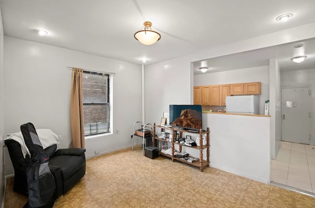 living area featuring light floors and baseboards