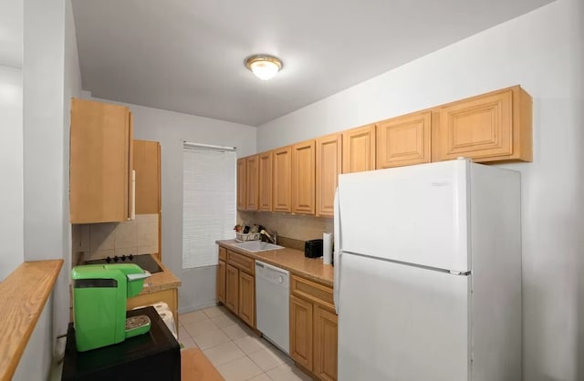 kitchen featuring light tile patterned floors, backsplash, white appliances, light brown cabinetry, and sink