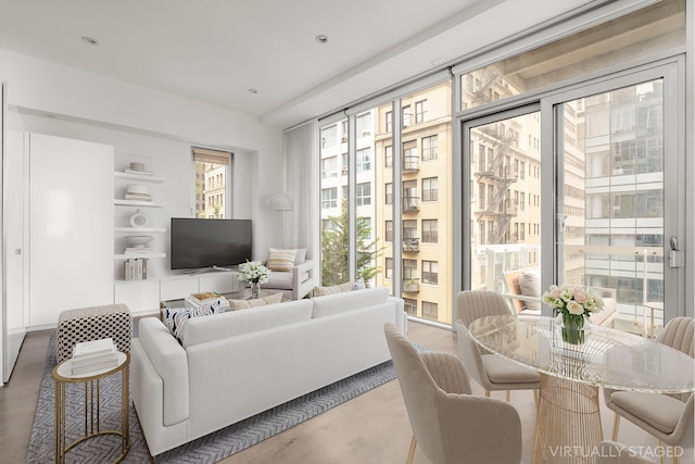 living room featuring built in features, recessed lighting, and wood finished floors