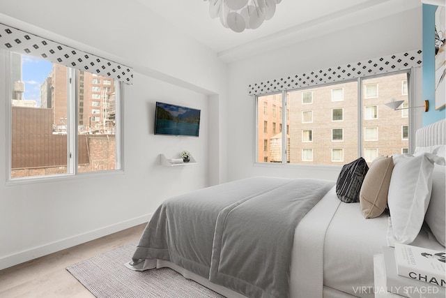 bedroom featuring baseboards and wood finished floors