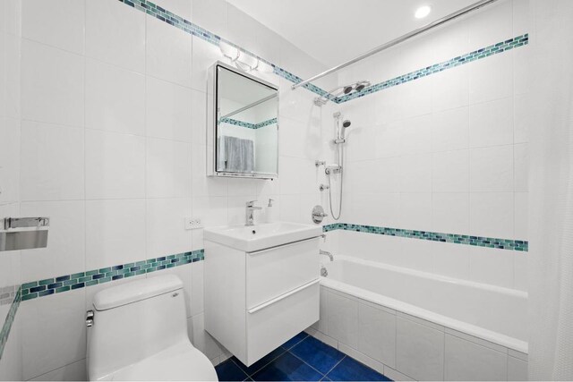 bathroom with vanity and tile walls