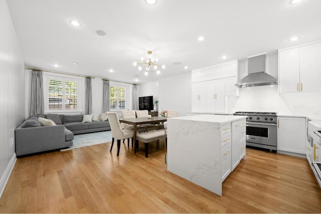 bedroom featuring a nursery area, hardwood / wood-style floors, and a wall unit AC