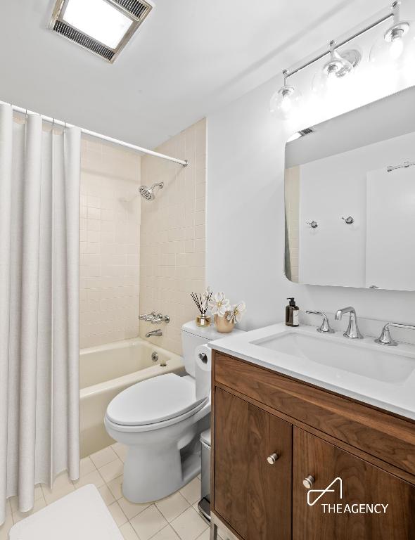 full bathroom featuring shower / tub combo, vanity, and toilet