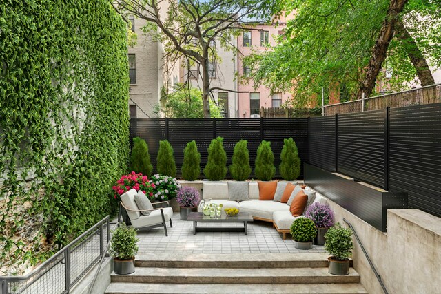 view of patio / terrace with an outdoor living space and fence